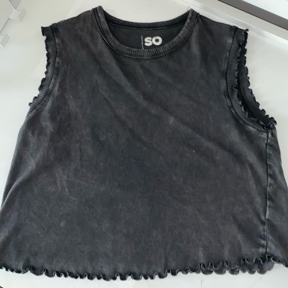 Top with ruffles on the arms and bottom. a light wash giving a distressed look